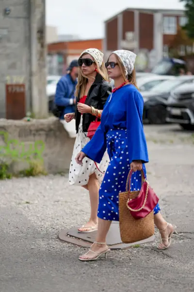 Woman wearing cobalt blue sweater and skirt during Copenhagen Fashion Week.