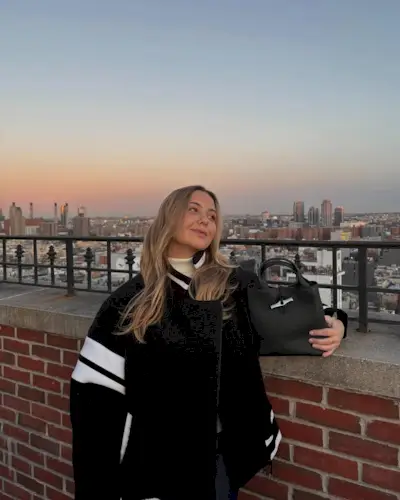 @oliviamarcus wears a varsity bomber jacket