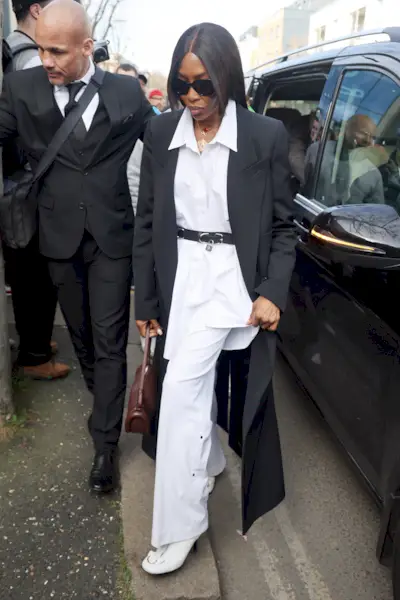 Naomi Campbell in white pants.