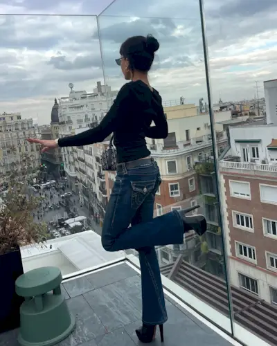 woman wearing flare true religion jeans and black top