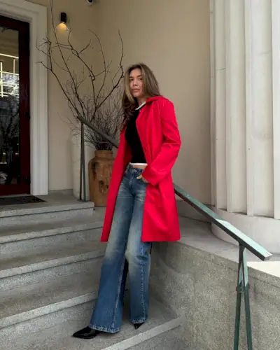 woman wearing flared jeans and red coat