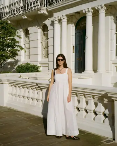 @francescasaffari wearing a white dress with black shoes