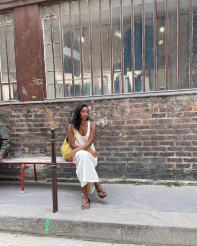 @rayan.xasan wearing a white dress with black shoes