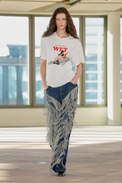 Model wears embellished jeans on the Stella McCartney runway.