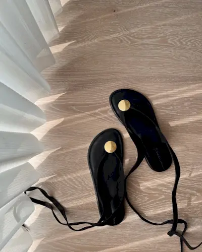 a pair of gold embellished sandals