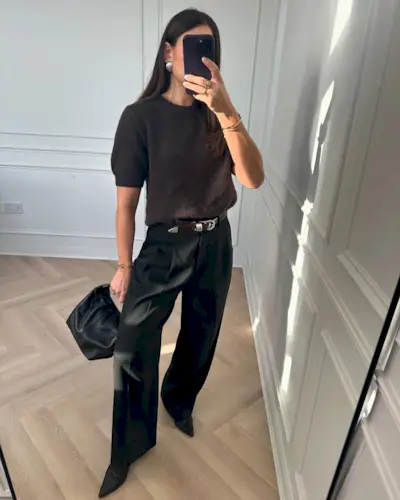 Woman wears short sleeve jumper in brown and black tailored trousers