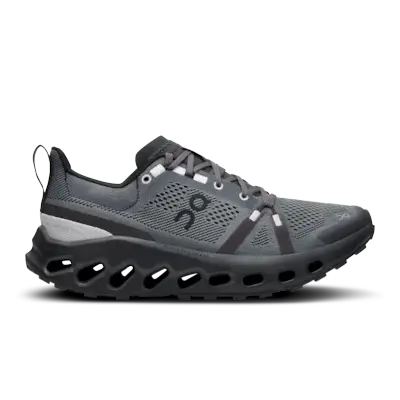 Dakota Johnson wears a black hat, black shirt, black leggings, and nike v2k black and gray sneakers.