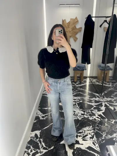 An image of Mommy's Reviews UK SEO Writer Ava Gilchrist wearing the Celine flared jeans Kendrick Lamar wore during his Super Bowl performance.