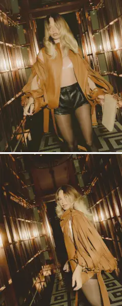 Photos of Lily James for Mommy's Reviews's August cover story. She is wearing a brown leather jacket with cutout detailing and leather shorts.