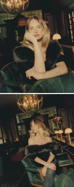 Photos of Lily James from the Mommy's Reviews August cover story. She is sitting in a dark hotel bar wearing an off-the-shoulder top with faux fur detailing and black pants.