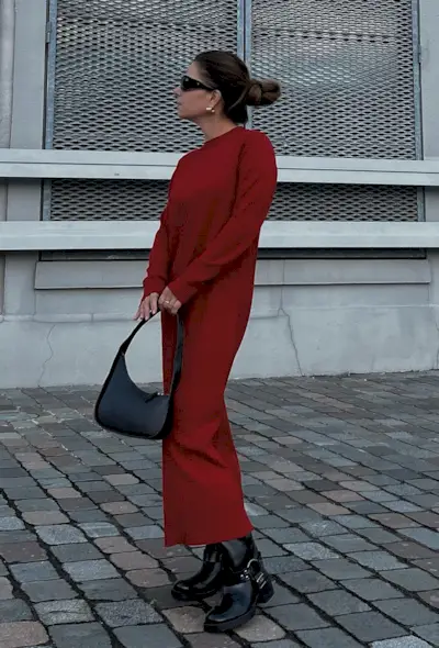 a photo of a woman wearing a red knit dress with black moto boots