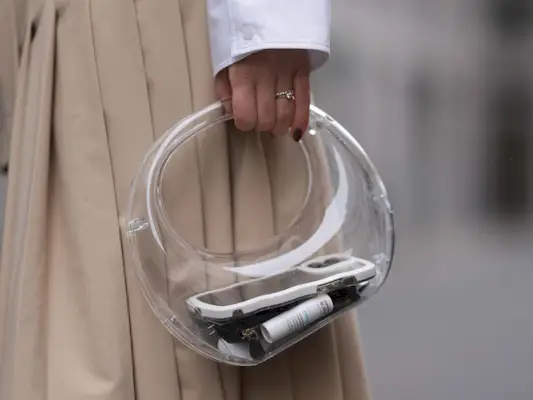 woman holding a see-through, clear, pvc bag