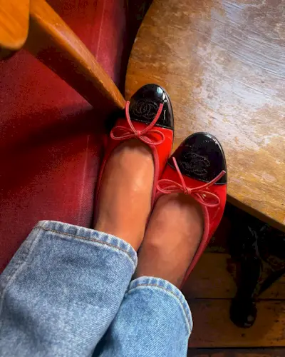 Influencer Emili Sindlev wearing red patent leather Chanel flats.