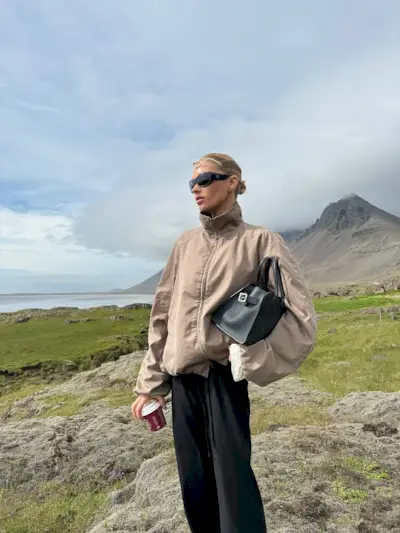 Elsa Hosk wearing a funnel-neck jacket and black pants in Iceland.