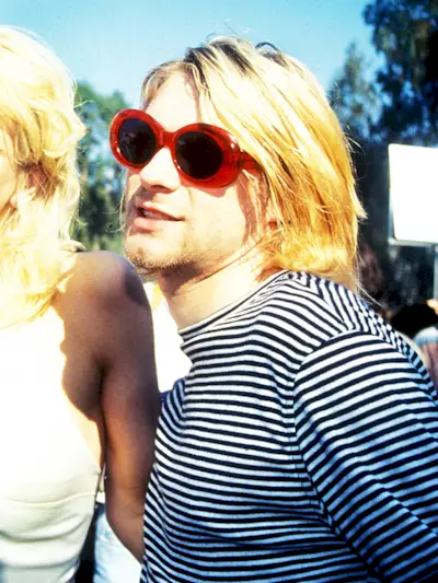 Kurt Cobain wearing red oval sunglasses in the '90s.