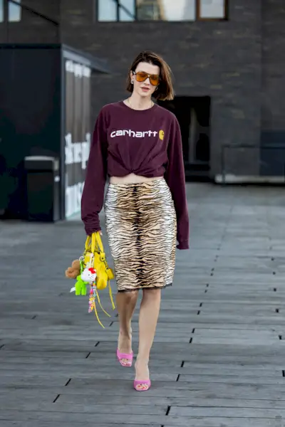 a woman wears a tiger-print knee-length skirt in Copenhagen