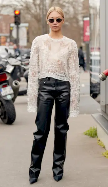 woman wearing leather pants and a sheer top