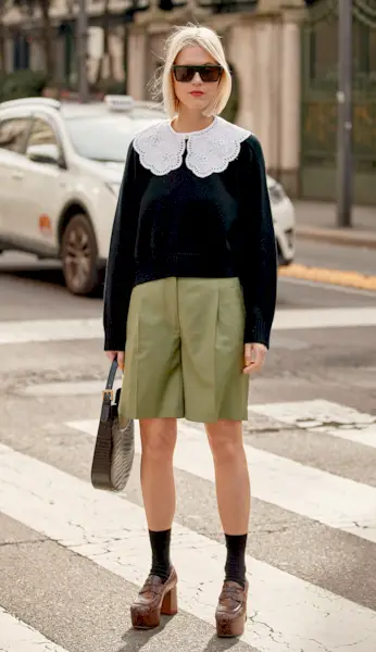 woman wearing sweater and bermuda shorts