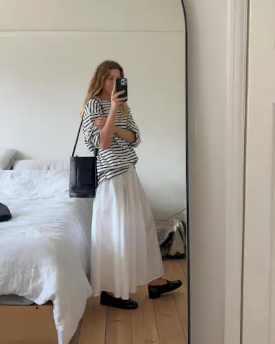 @brittanybathgate wearing a Breton stripe T-shirt with a white skirt and flats.