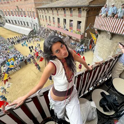 Woman wearing crop top and cargo pants.