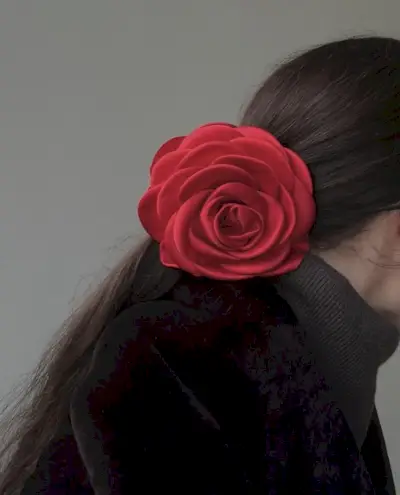 Woman wearing red satin rosette clip from Pico.