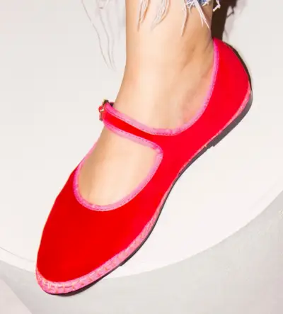 Woman wearing red velvet and pink trim Mary Jane espadrilles from Flabelus.