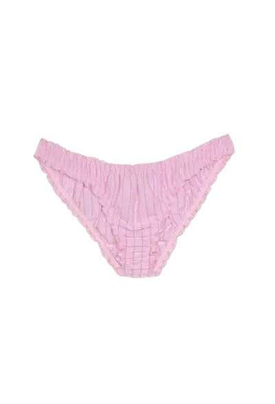 Model wearing pink shirt and patterned green shorts from Caro Editions.