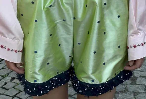 Model wearing green polka dot Caro Editions shorts.