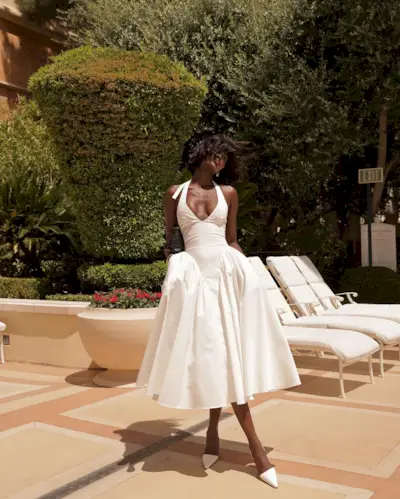 Influencer wears a basque waist dress.