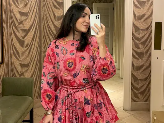 a roundup of outfits to wear on a first date, specifically a close photo of a woman wearing a pink dress