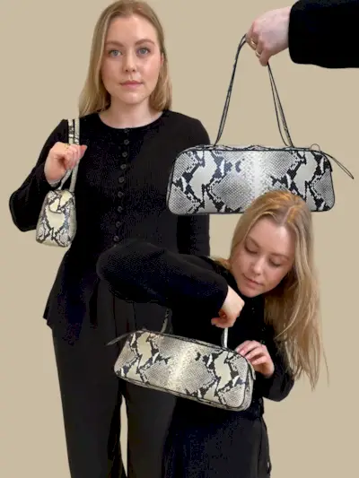Woman wears black top and carries snakeskin bag