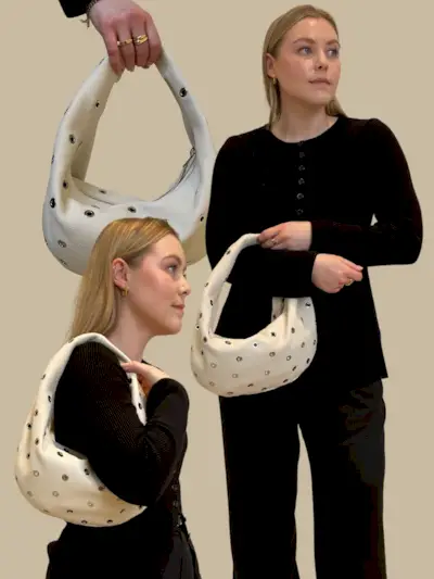 Woman carries Olivia bag by Khaite