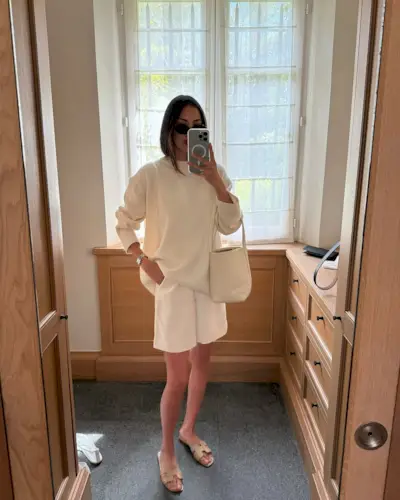 woman wearing white trousers and sweater