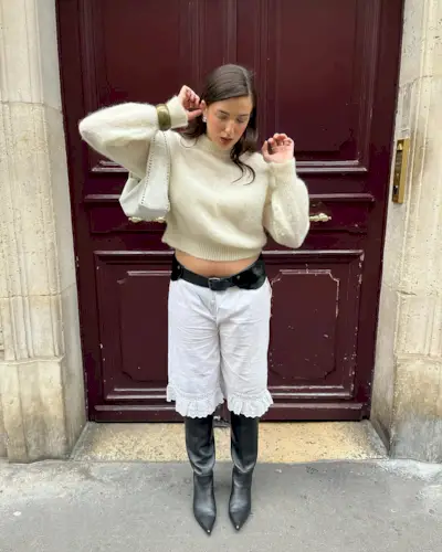 woman wearing long white ruffle shorts with black boots