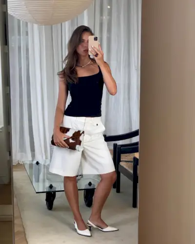 woman wearing white long shorts with white kitten heels