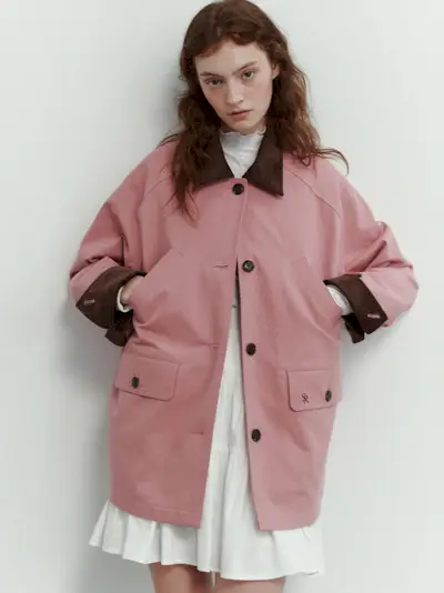 Woman in black sporty jacket, jeans, and boots