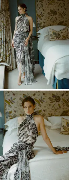 Actress Louisa Jacobson wears a scarf-print Dries Van Noten halter dress with Sauer jewels. She is posing for portraits inside her hotel room before The Gilded Age season 3 premiere.