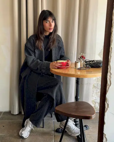 Woman wearing chunky sneakers in Paris.