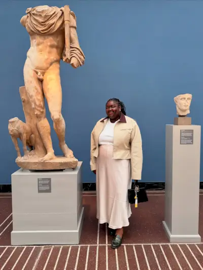 An image of @abimarvel wearing a loafers outfit with a slip skirt and barn jacket.