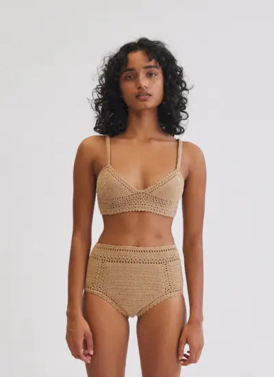 a model wears a tan bikini top and matching high-rise bikini bottoms