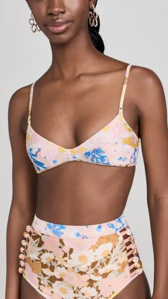 a model wears a multi-colored floral bikini top and matching high-rise bottoms