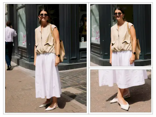 A woman wears a sleeveless shell top with a white full skirt in London