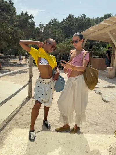 @mv.tiangue wears a polkadot skirt and bikini whilst carrying a blue Chanel bag
