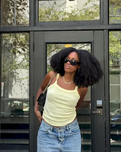 woman wearing yellow tank top summer outfit 2025