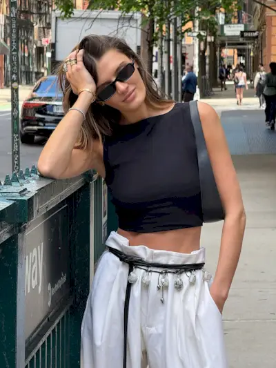 woman wearing black crop top and white pants