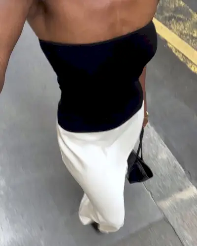 woman wearing strapless black top and white skirt