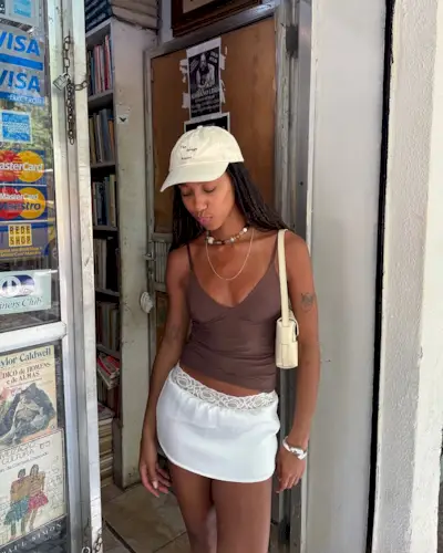 woman wearing brown tank top and white skirt summer outfit 2025