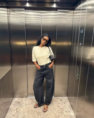 Marilyn in black jeans and jelly flip-flops and graphic T-shirt