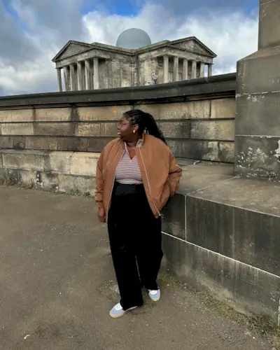 Abi wearing black wide-leg trousers