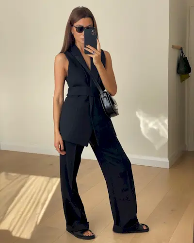 Marianne wearing black wide-leg trousers